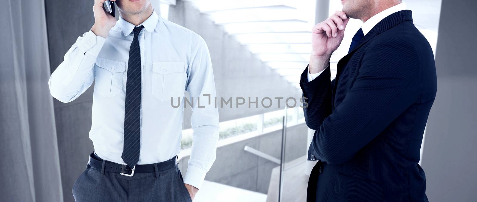 Composite image of elegant businessman in suit posing  by Wavebreakmedia