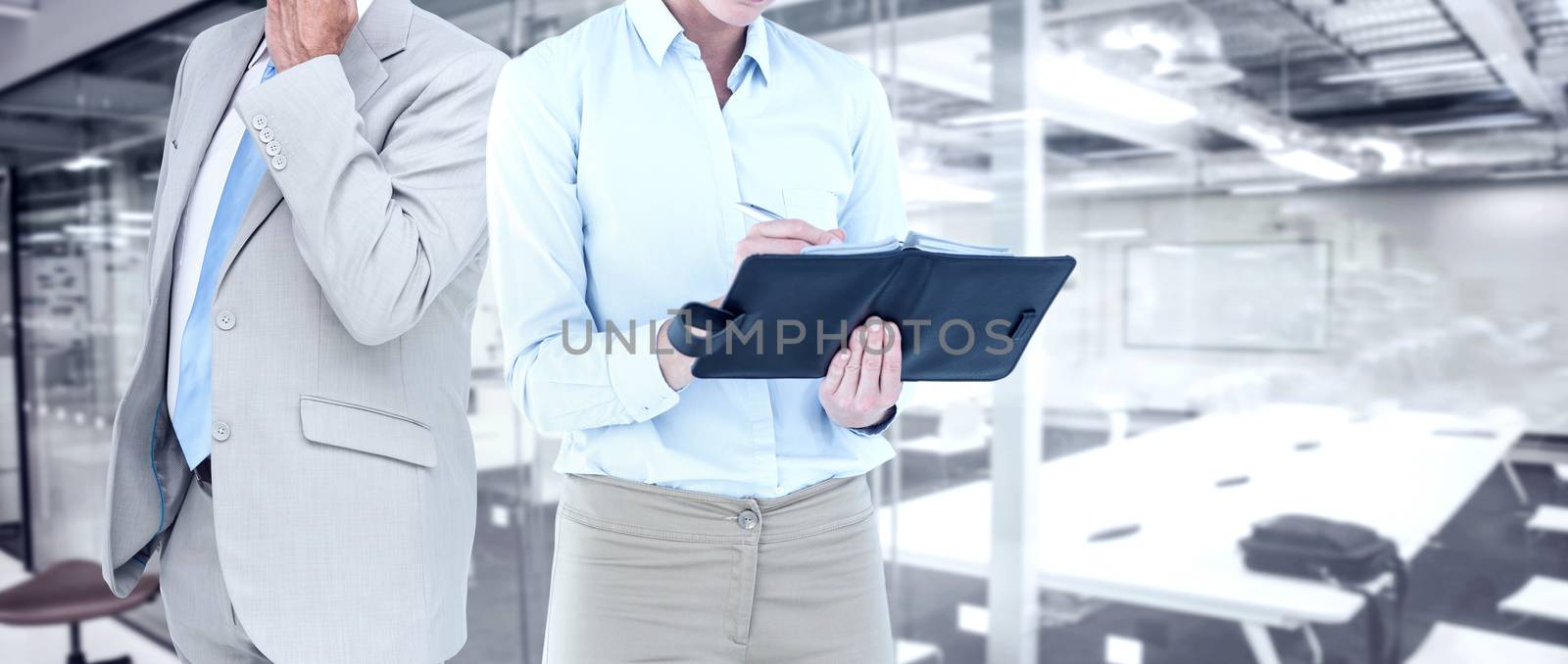 Composite image of businesswoman writing in her diary  by Wavebreakmedia