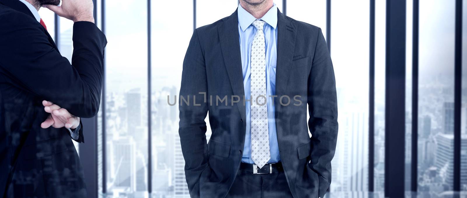 Businessman looking at the camera against room with large window looking on city