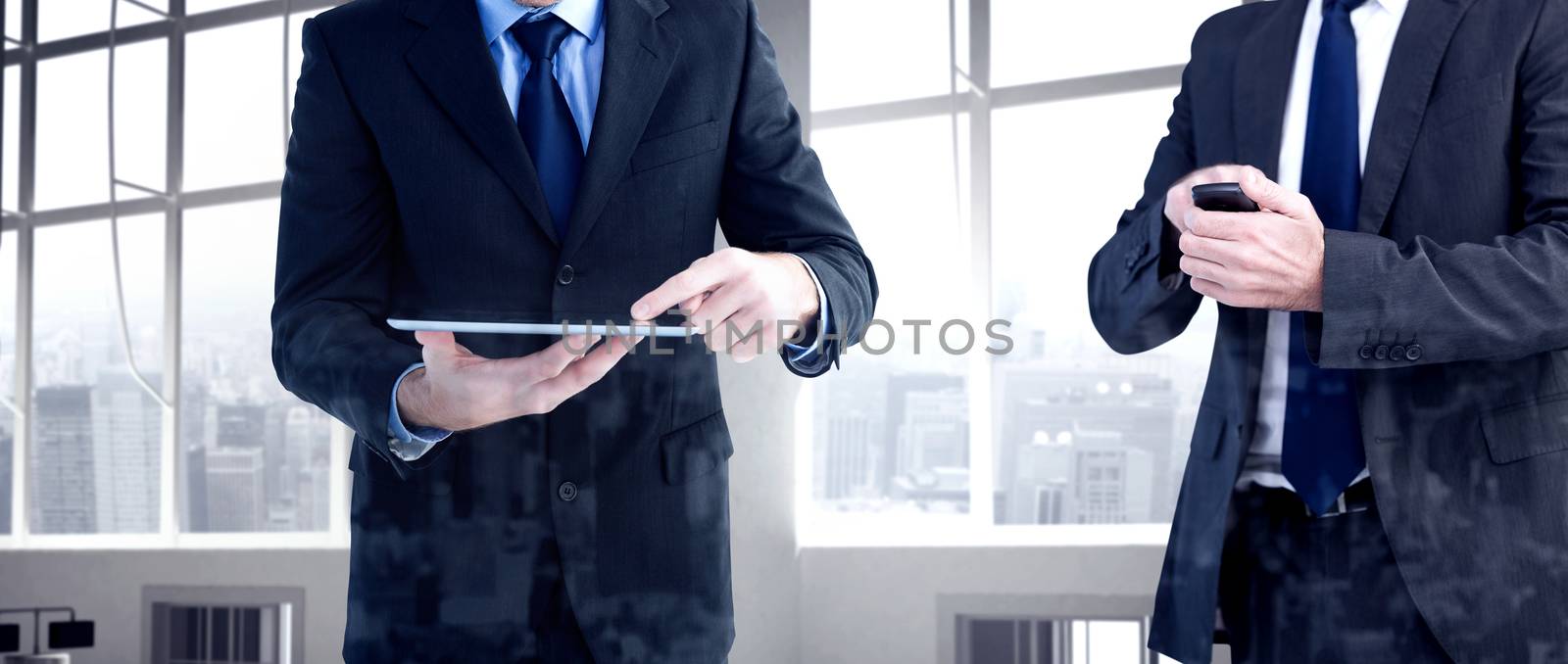 Composite image of focused businessman texting on his mobile phone by Wavebreakmedia