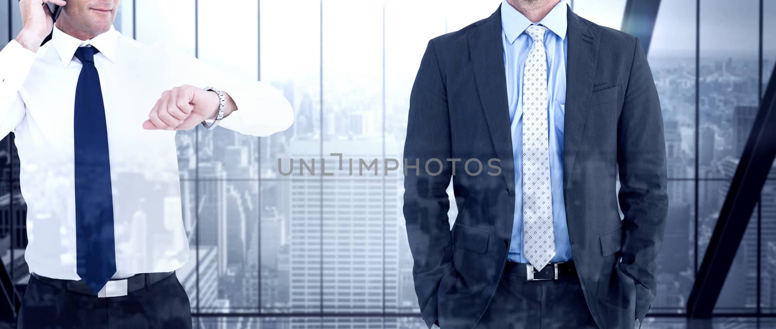 Businessman on the phone looking at his wrist watch against room with large window looking on city