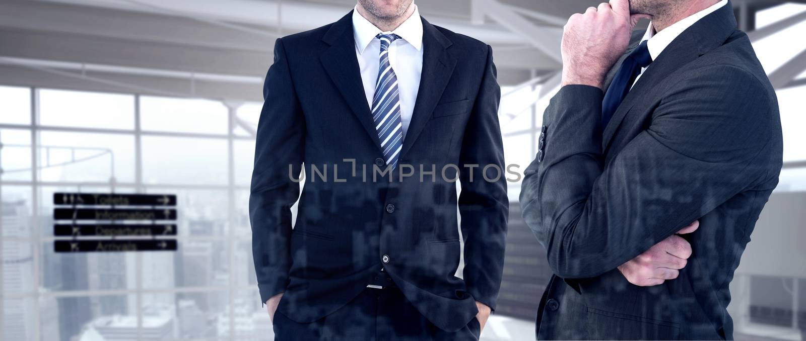 Frowning businessman thinking  against airport terminal