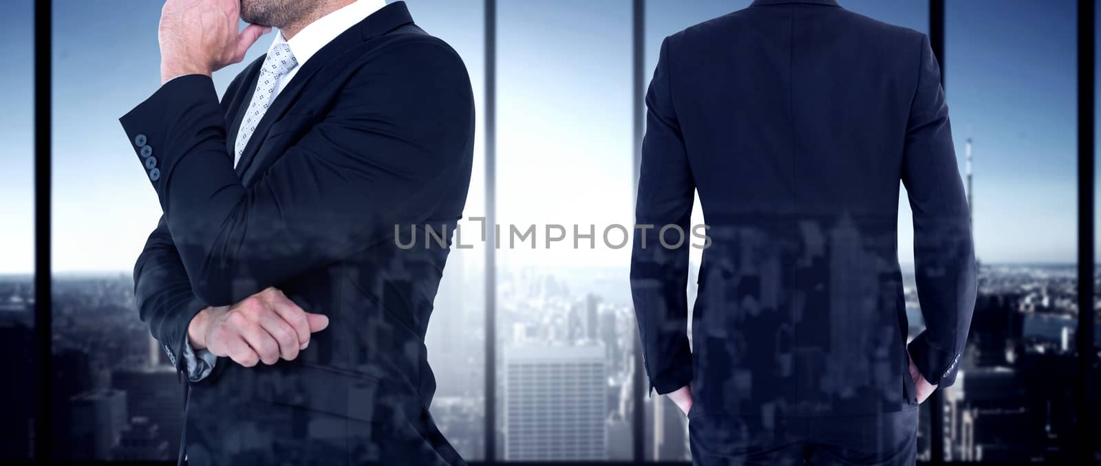 Rear view of handsome businessman  against room with large window looking on city