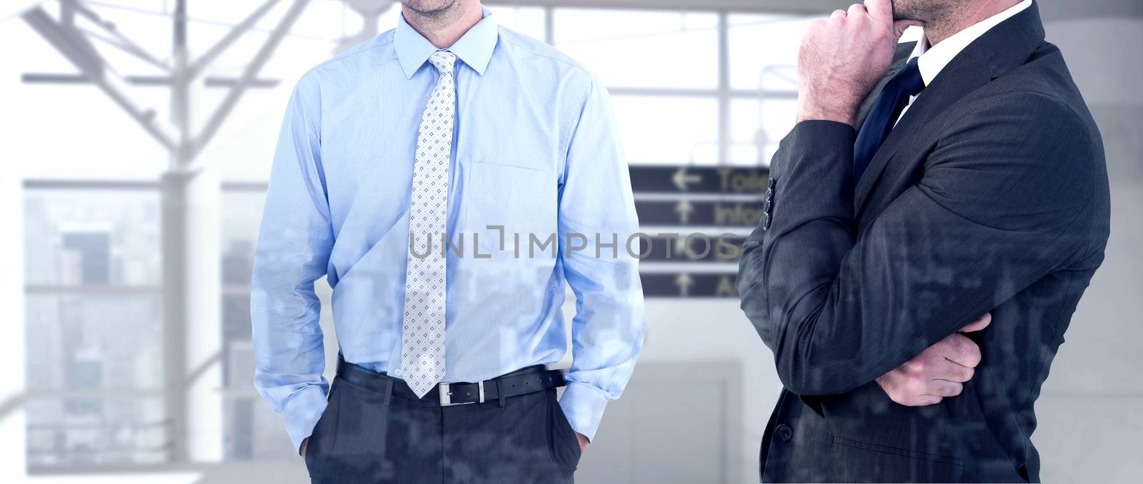 Frowning businessman thinking  against airport terminal