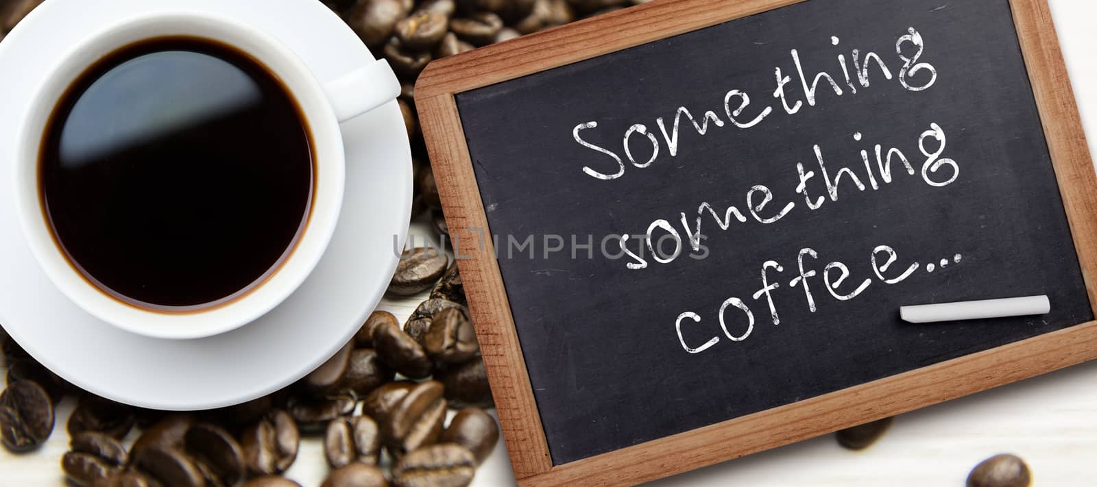 White cup of coffee against chalkboard with piece of chalk