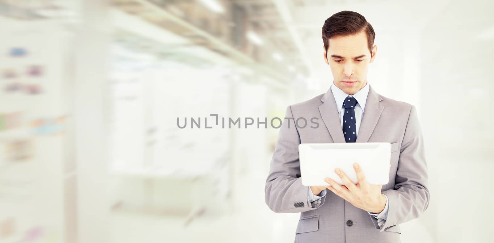 Composite image of businessman holding a tablet computer by Wavebreakmedia