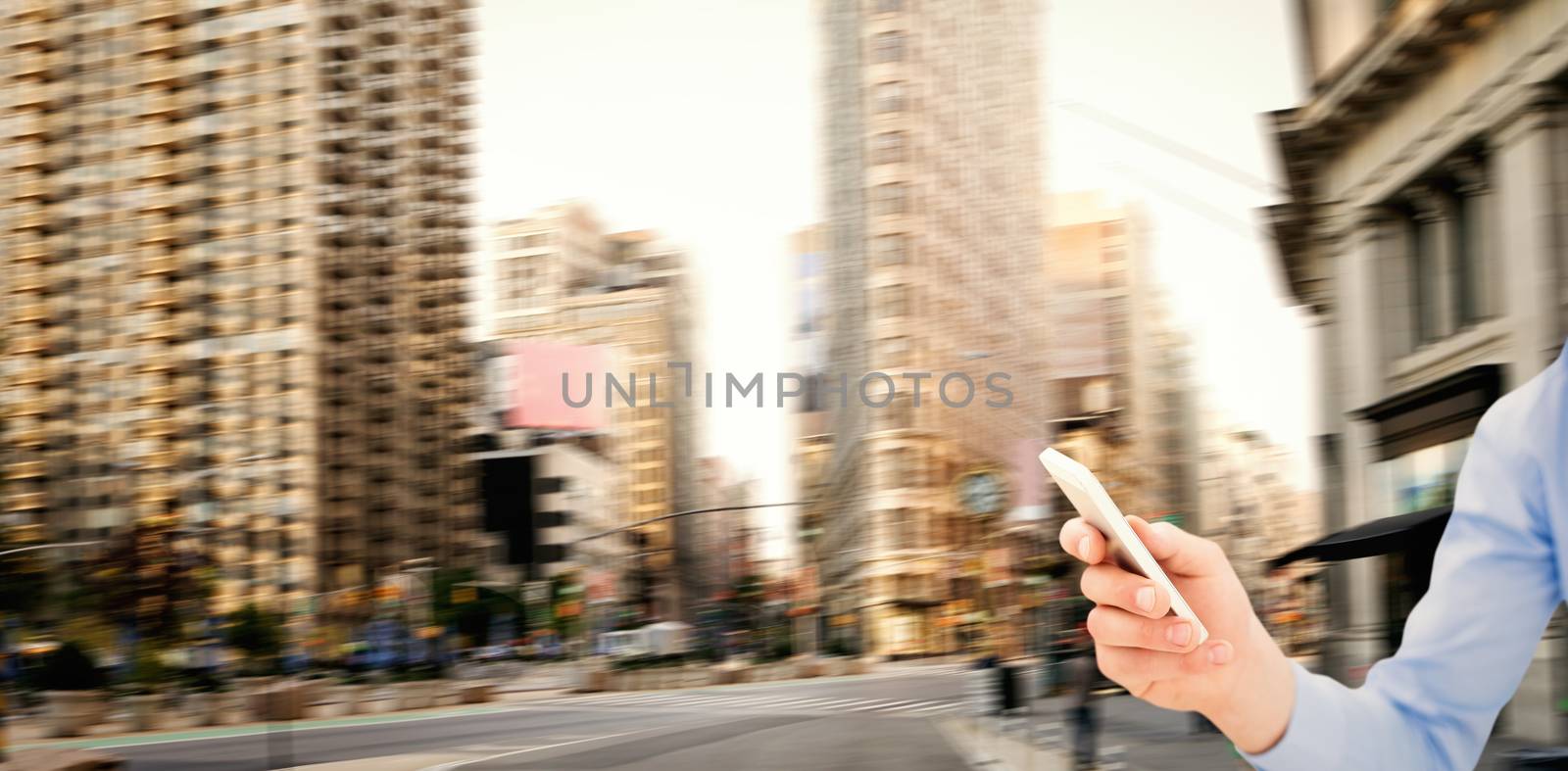 Man using smartphone against new york street