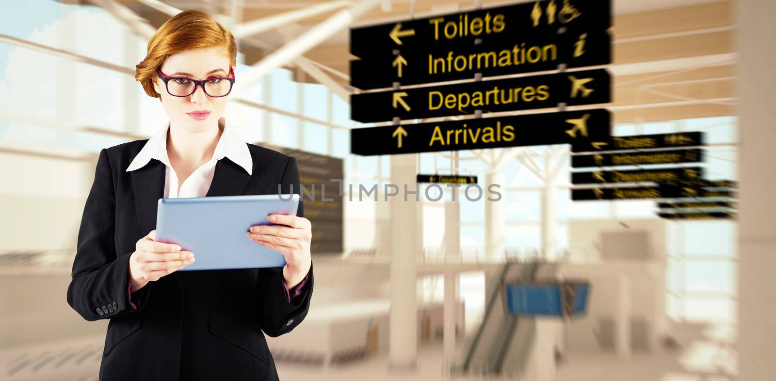 Redhead businesswoman using her tablet pc against airport