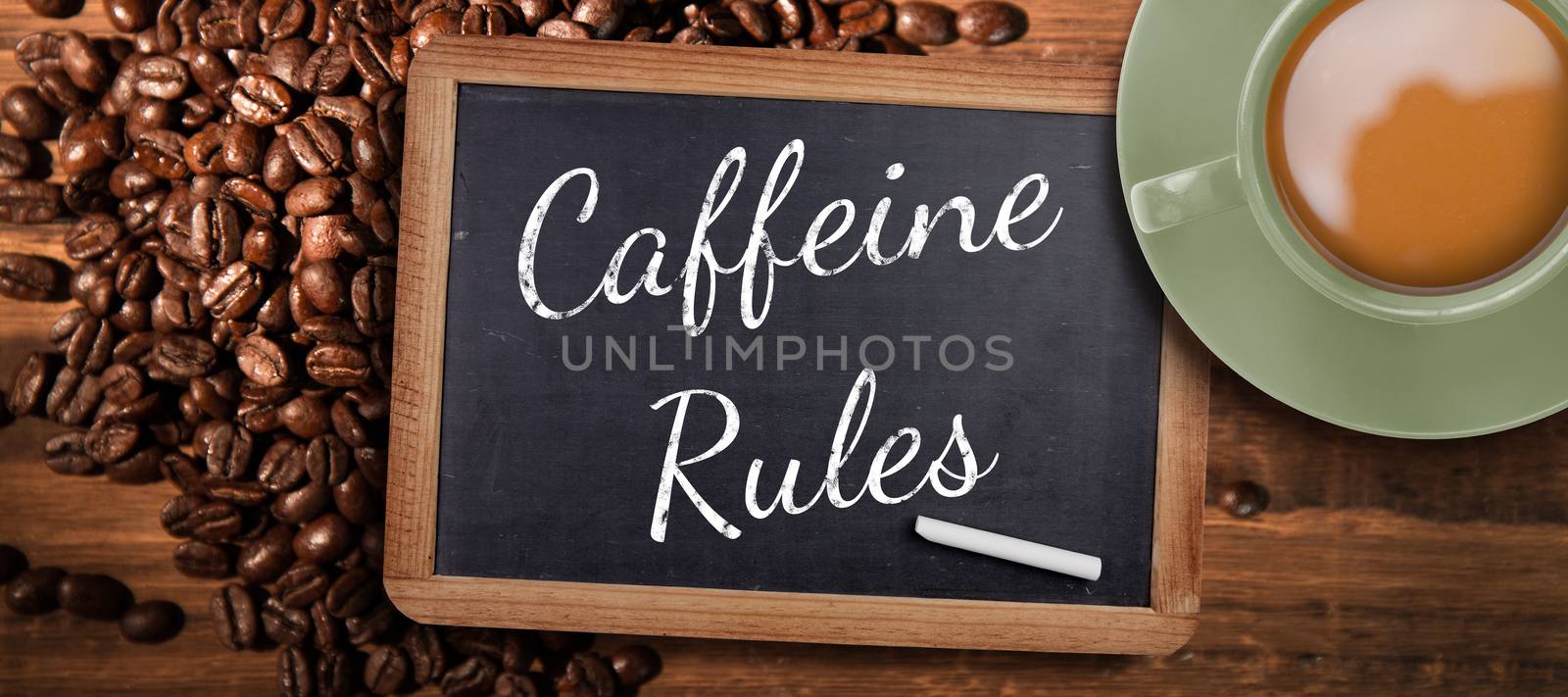 Green cup of coffee against chalkboard with piece of chalk