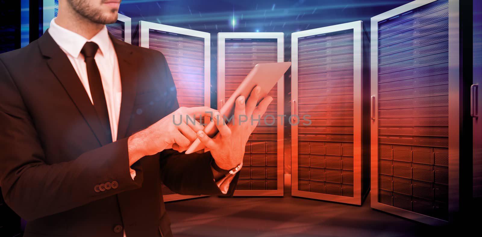 Mid section of a businessman using digital tablet pc against composite image of server room