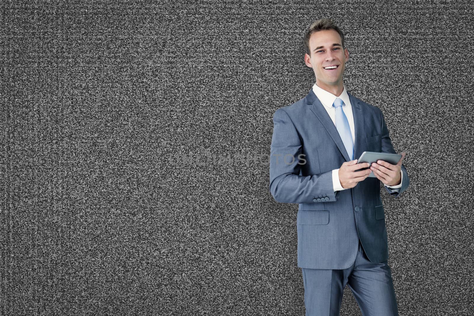 Businessman using tablet against black background