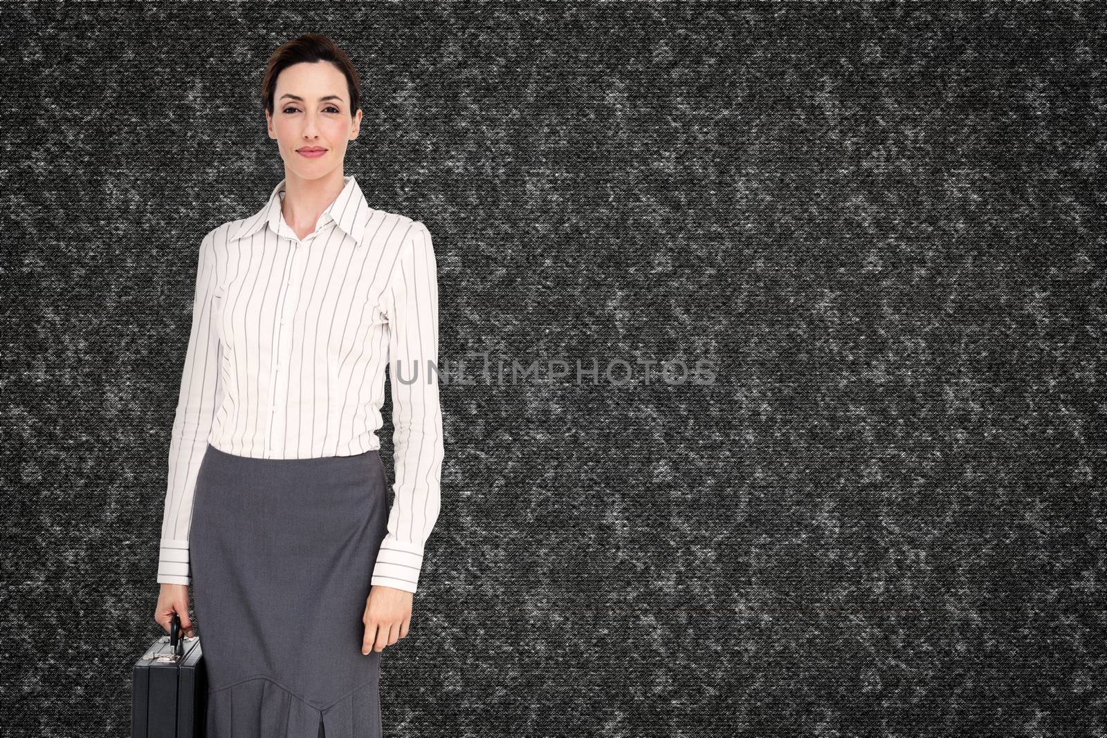 Composite image of businesswoman holding briefcase by Wavebreakmedia