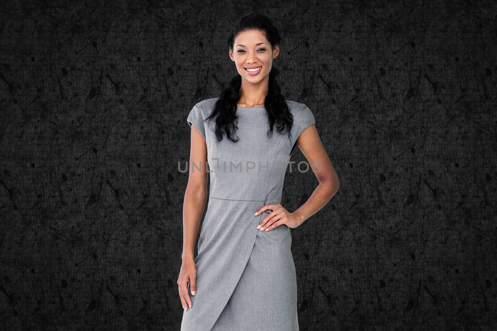 Businesswoman smiling against grey background