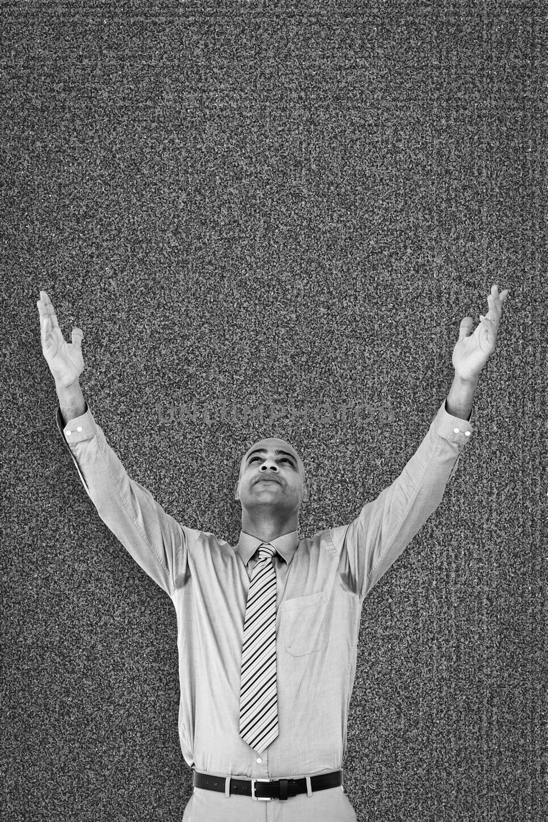 Happy businessman against black background