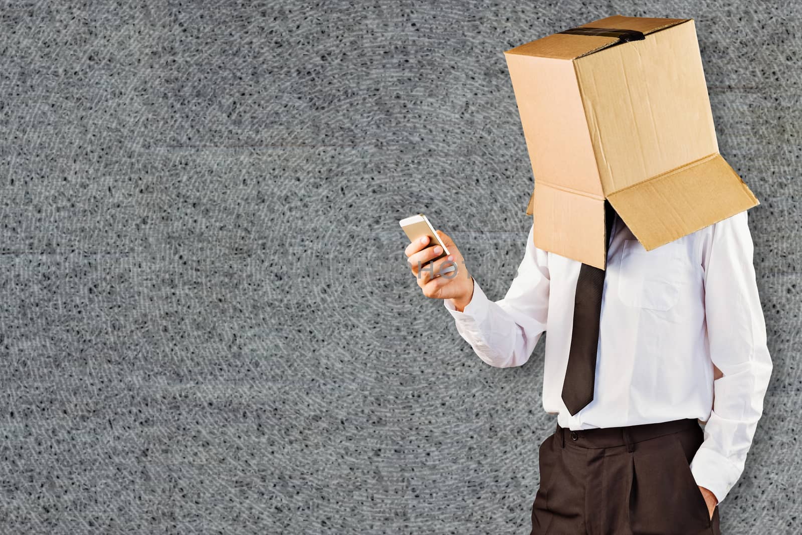 Anonymous businessman with his smartphone against grey background