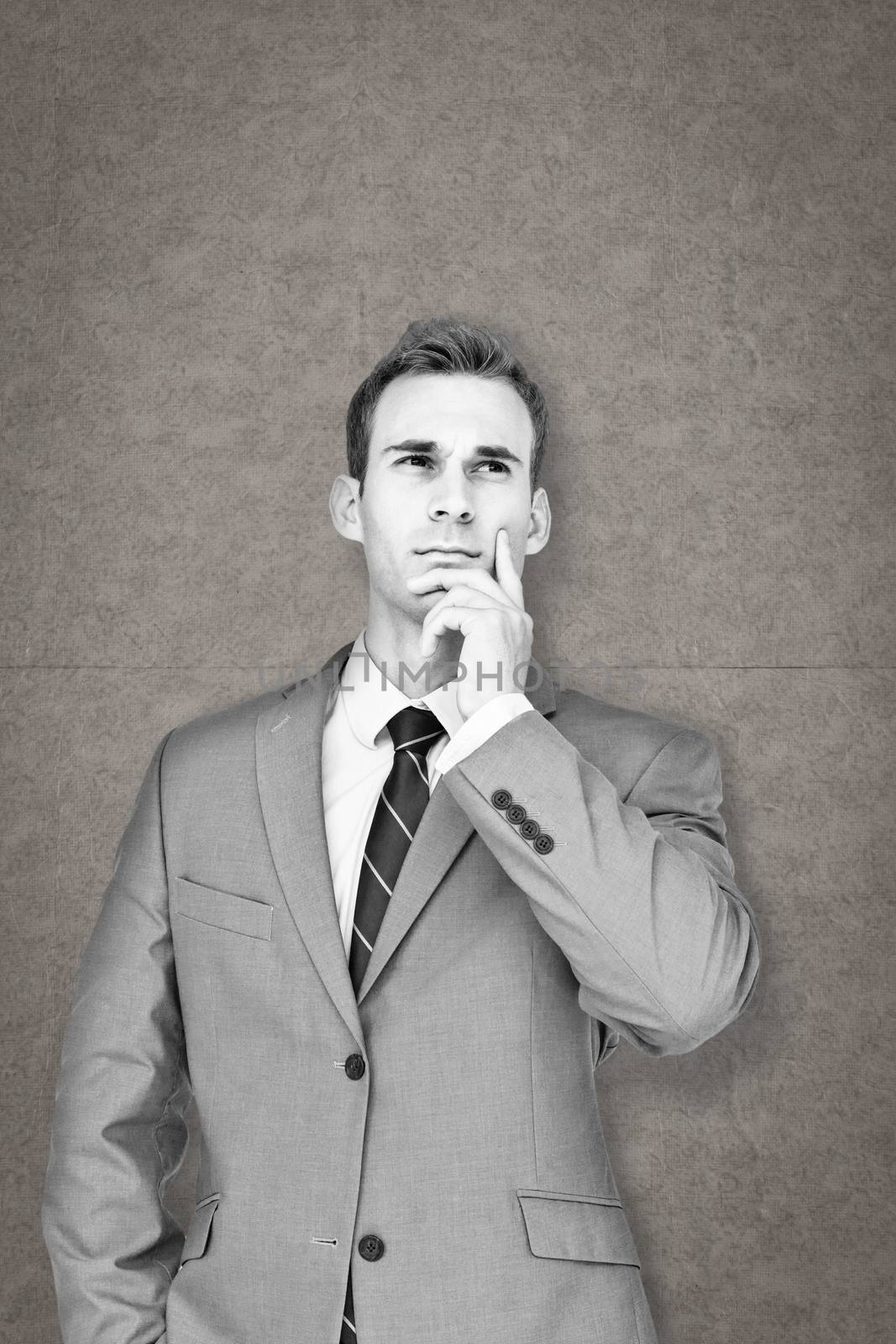 Businessman thinking against grey background