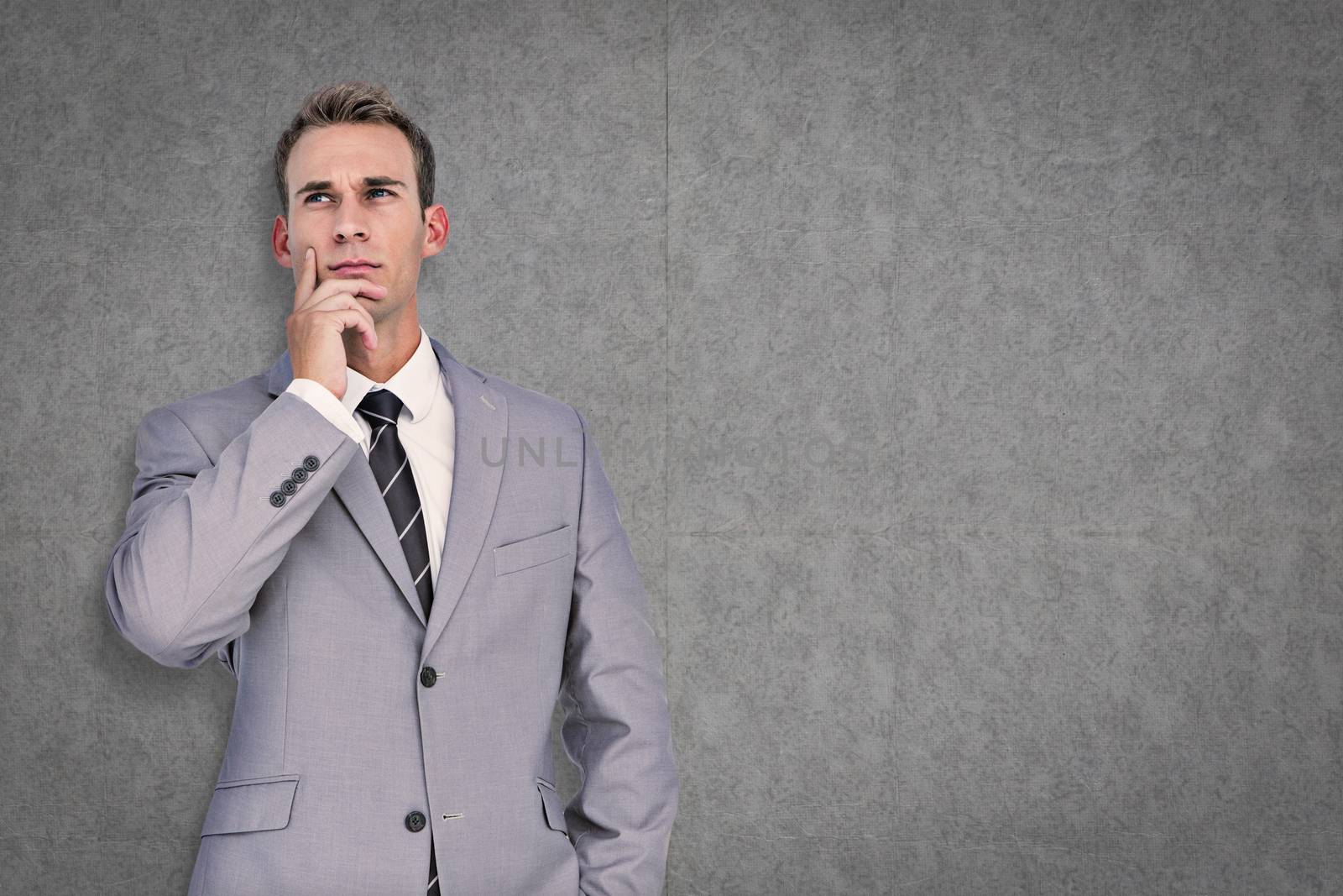 Businessman thinking against grey background