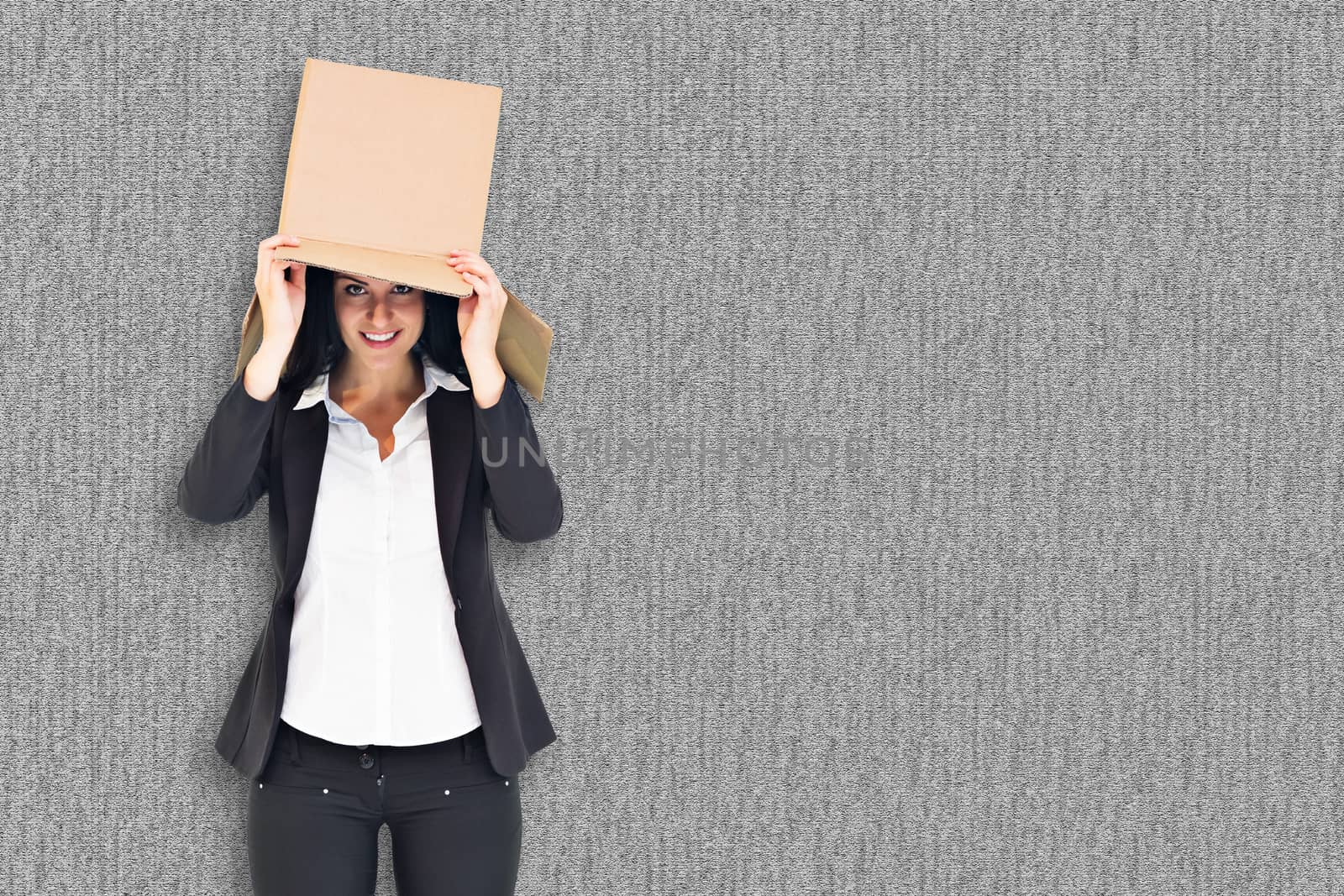 Anonymous businesswoman holding a megaphone against grey background