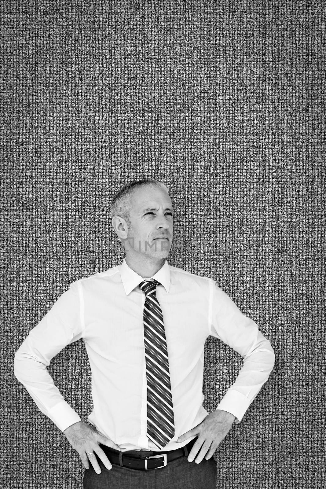 Thinking businessman against grey background