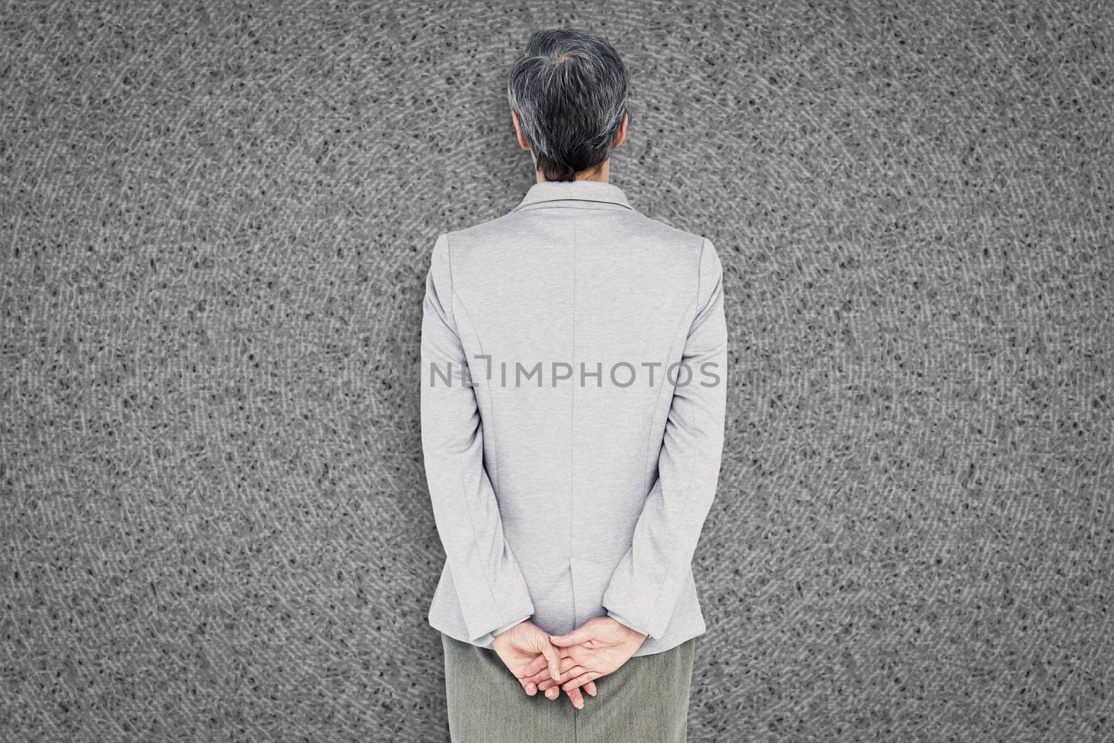 Businesswoman standing against grey background