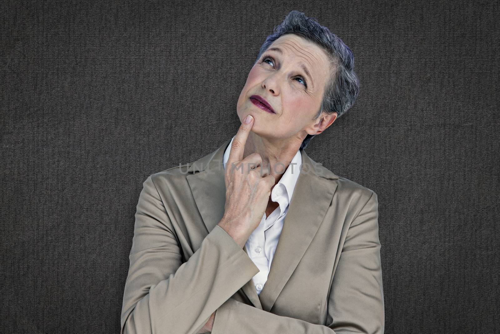 Businesswoman thinking against grey background