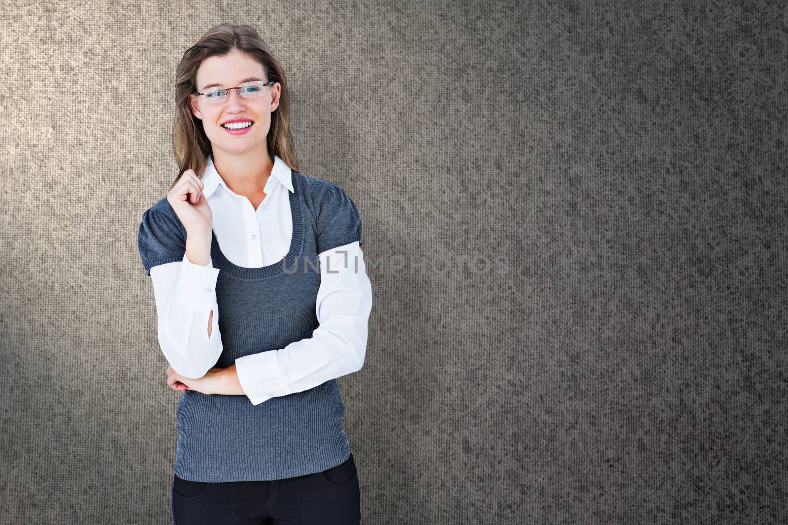 Smiling woman looking at camera  against grey background