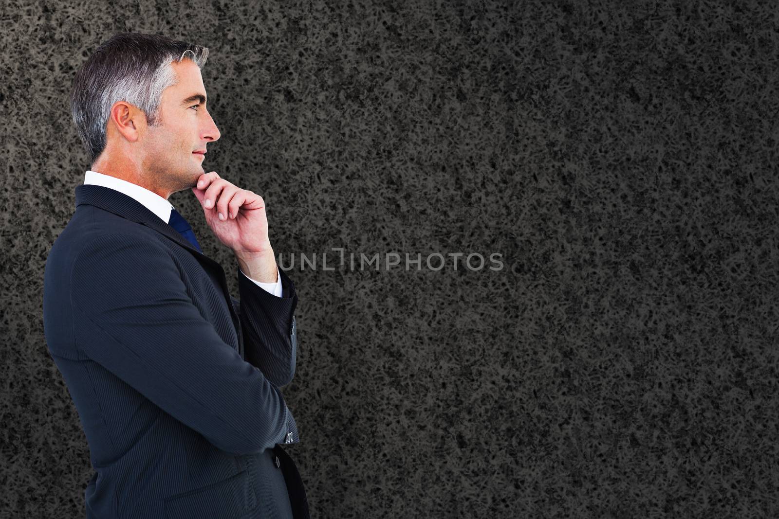 Composite image of elegant businessman in suit posing  by Wavebreakmedia