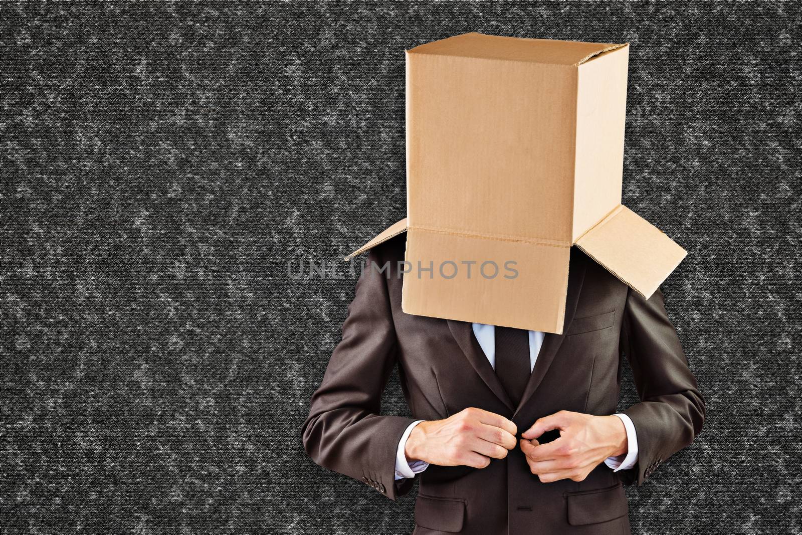 Anonymous businessman buttoning his jacket against black background