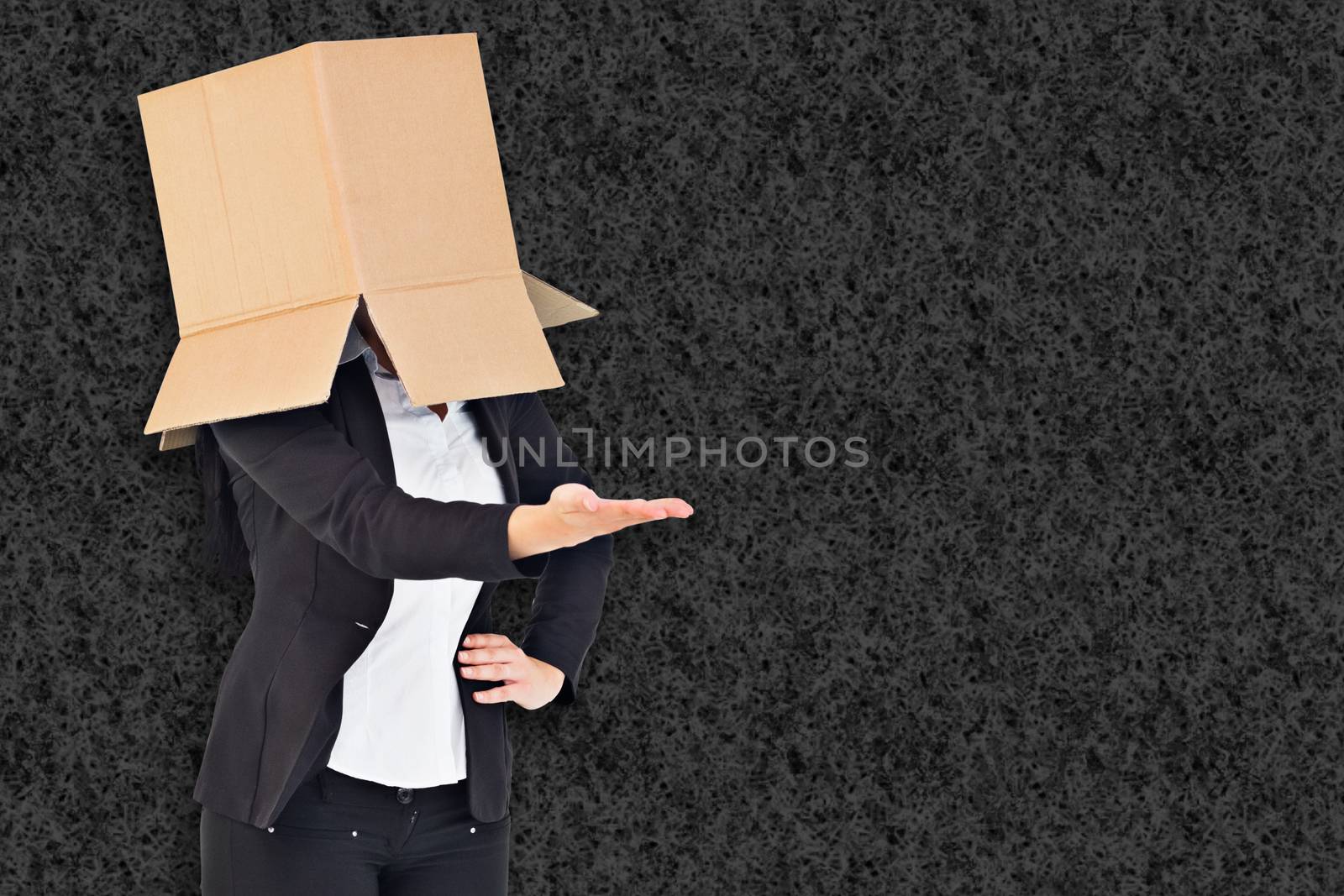 Businesswoman presenting with box over head against grey background