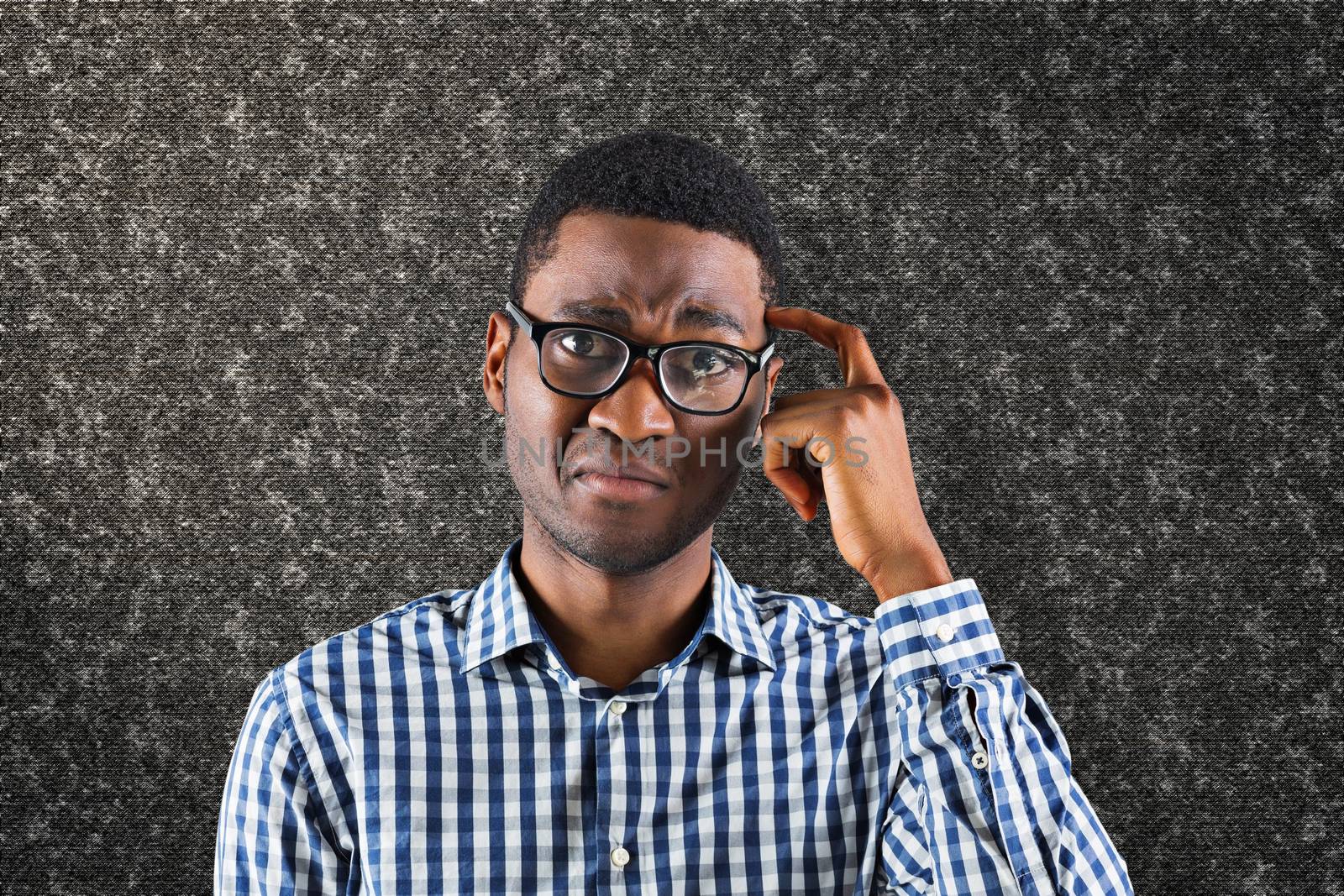 Confused casual businessman against black background