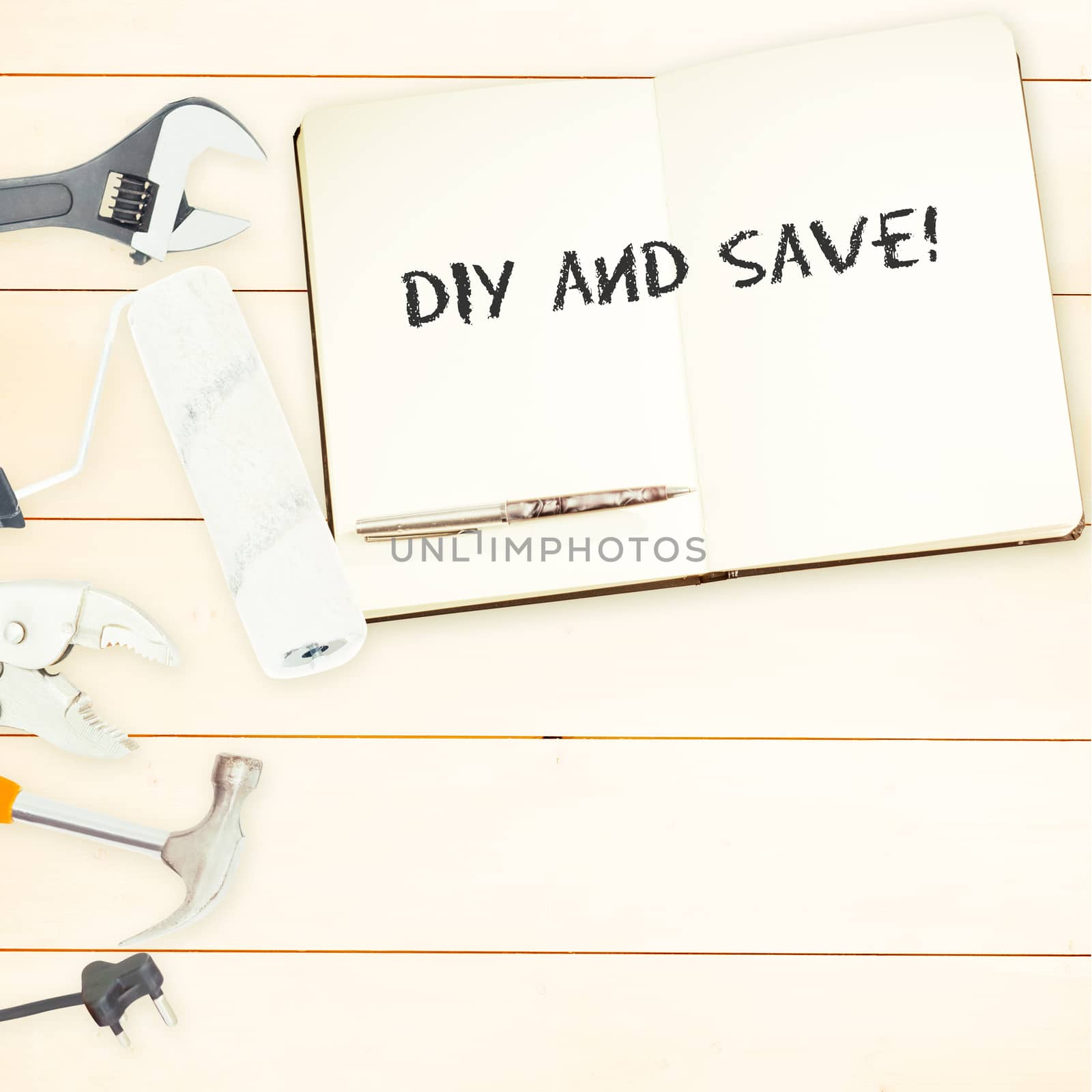 The word diy and save! against tools and notepad on wooden background