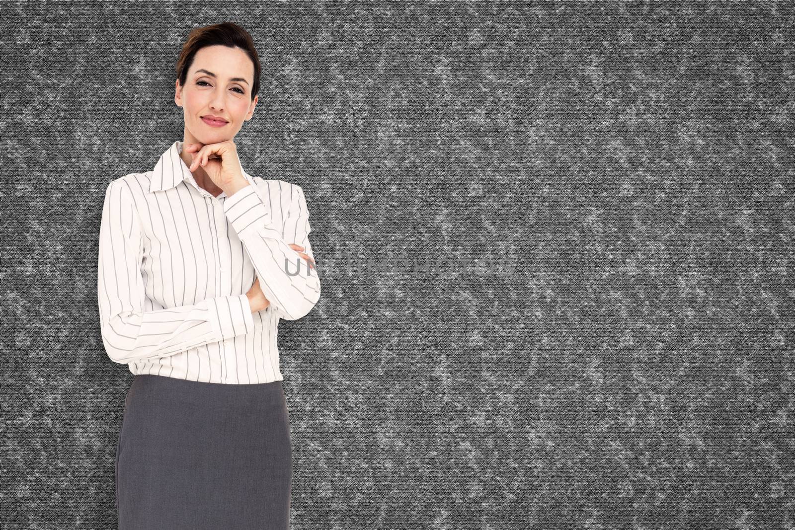 Smiling businesswoman against grey background