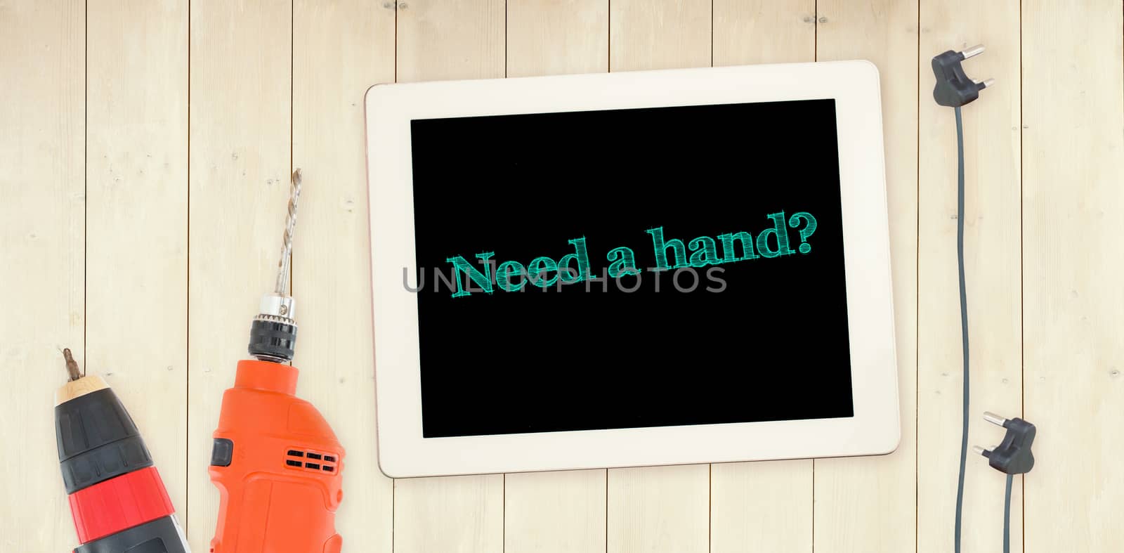 The word need a hand? against tools and tablet on wooden background