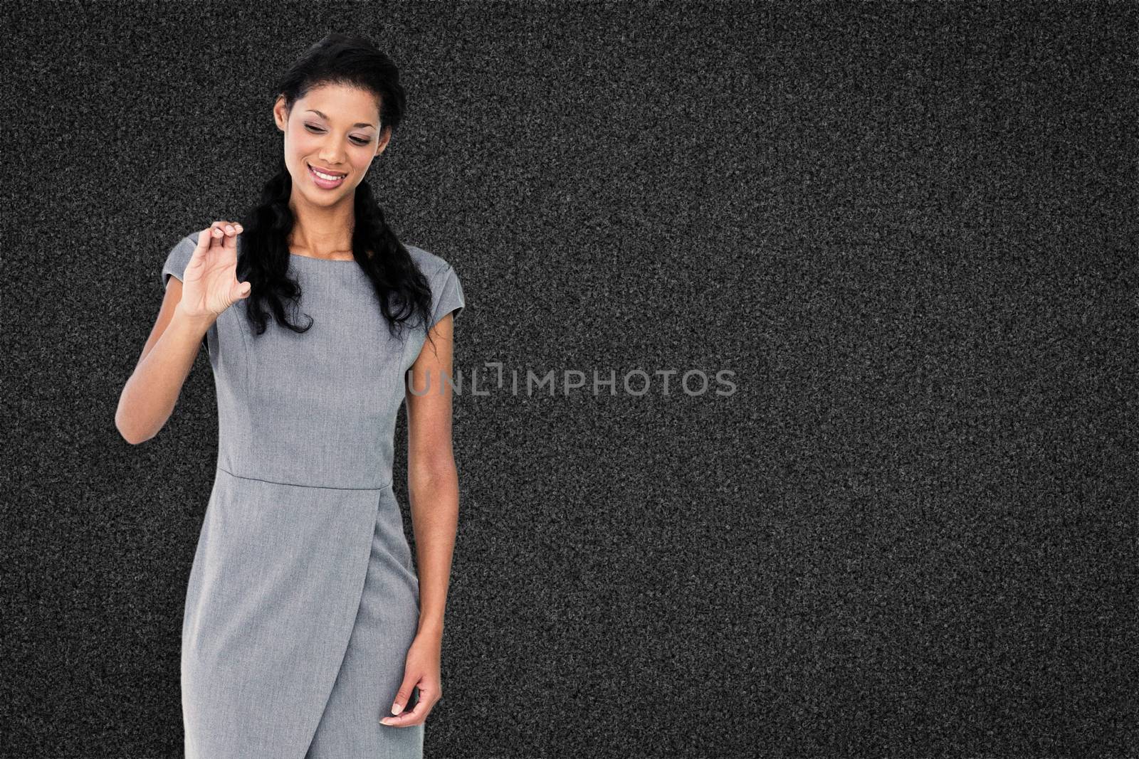 Businesswoman smiling against black background