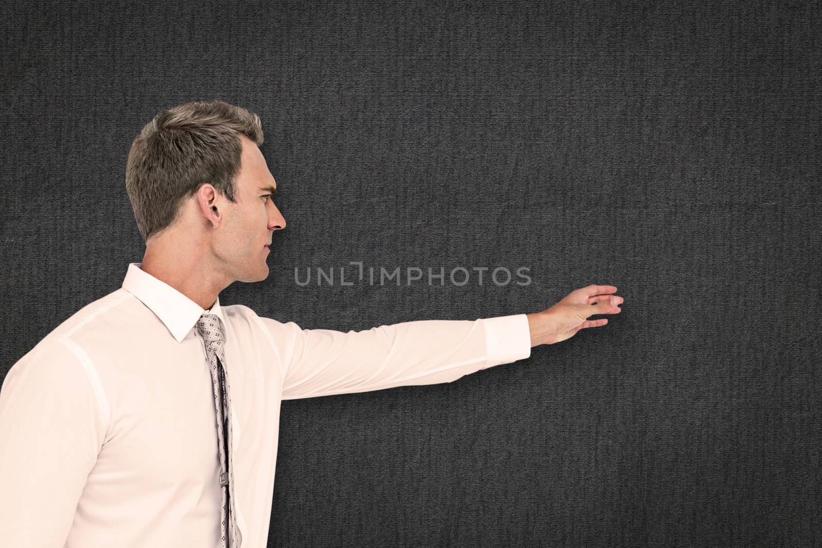 Composite image of businessman reaching by Wavebreakmedia