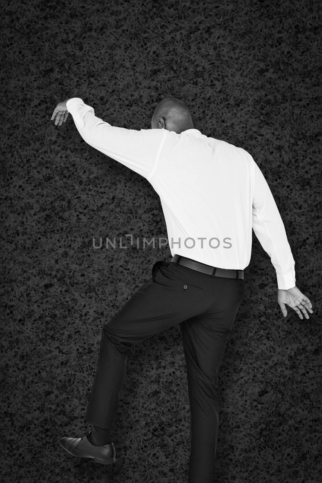 Businessman stepping against grey background