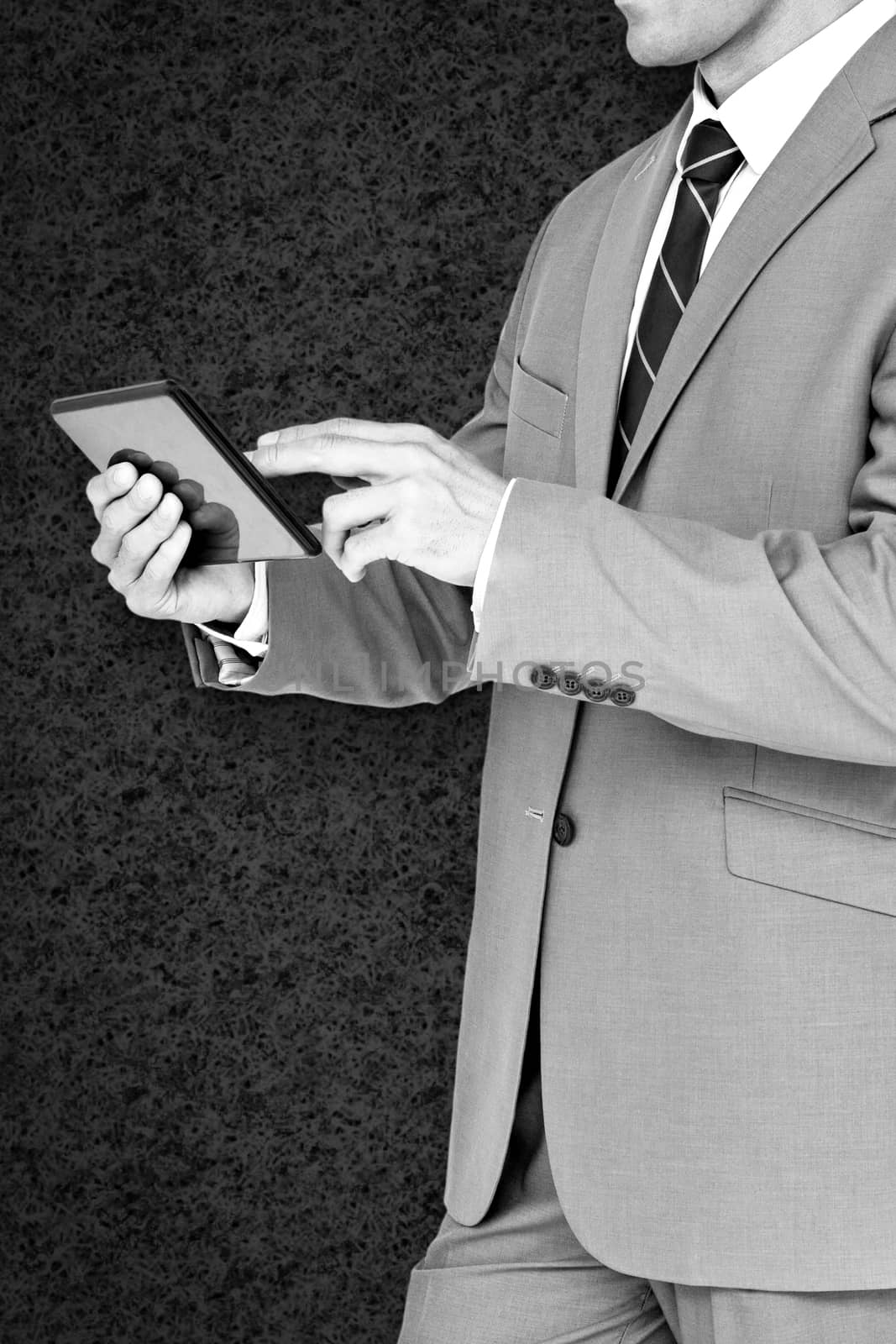 Composite image of businessman using tablet pc by Wavebreakmedia