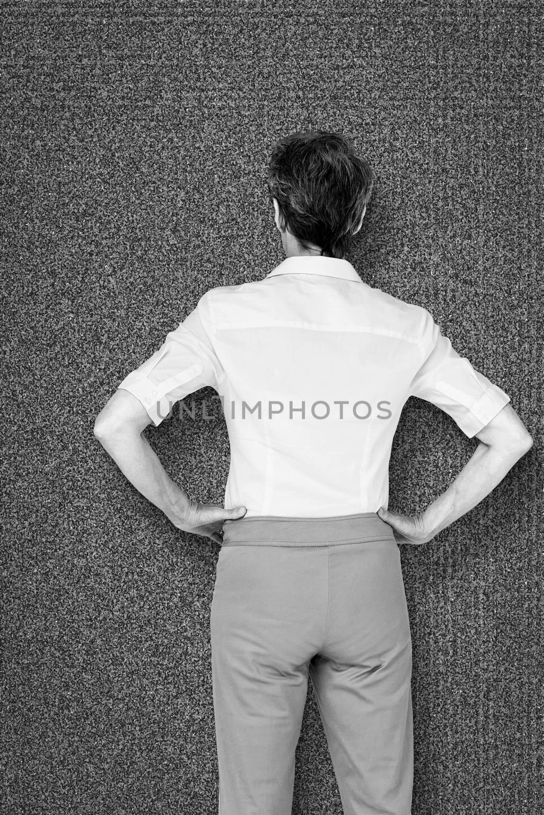 Businesswoman standing against black background