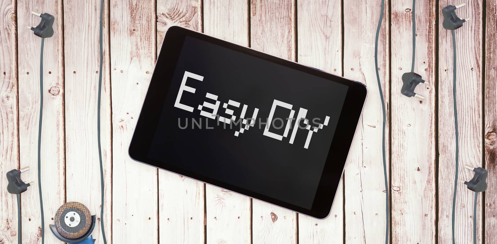 The word easy diy against tablet pc on wooden surface