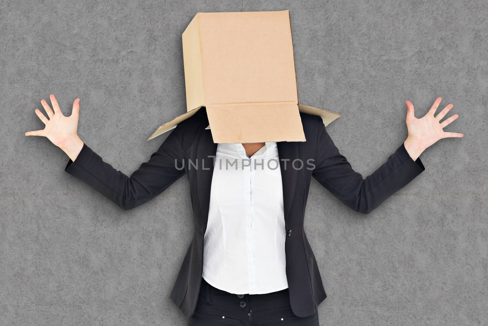 Anonymous businesswoman with her hands up against grey background