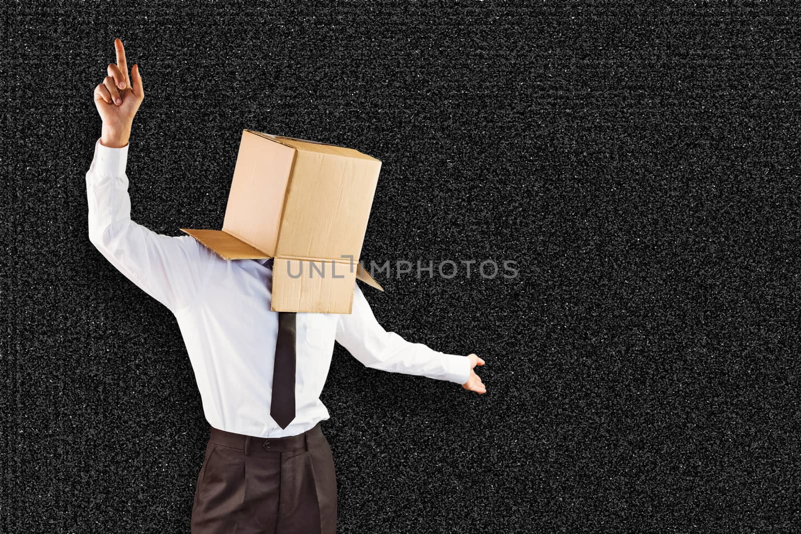 Anonymous businessman with arms out against black background