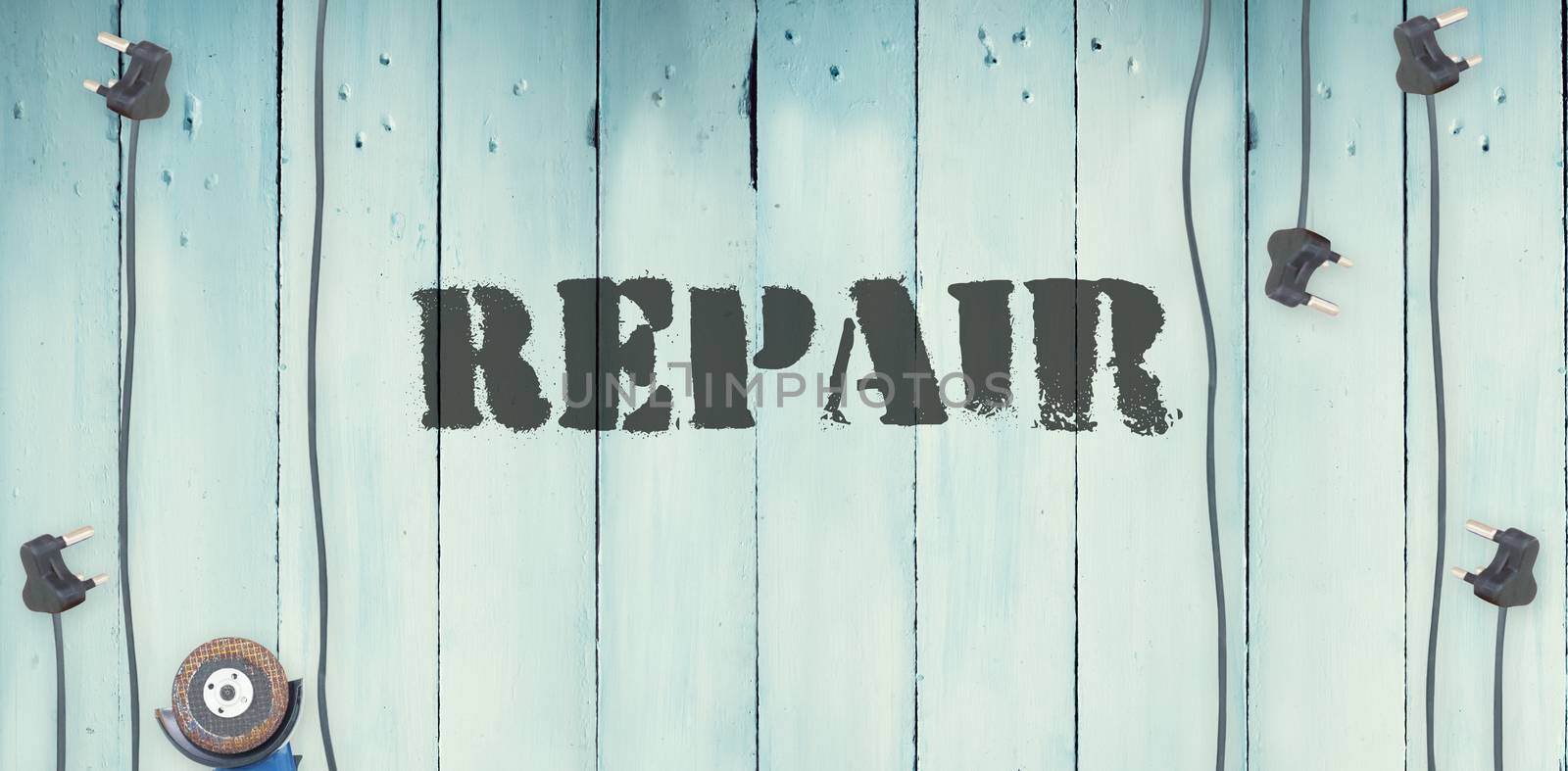 The word repair against plugs on wooden background