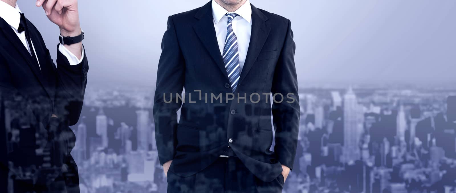 Smiling businessman standing with hands in pockets against high angle view of city