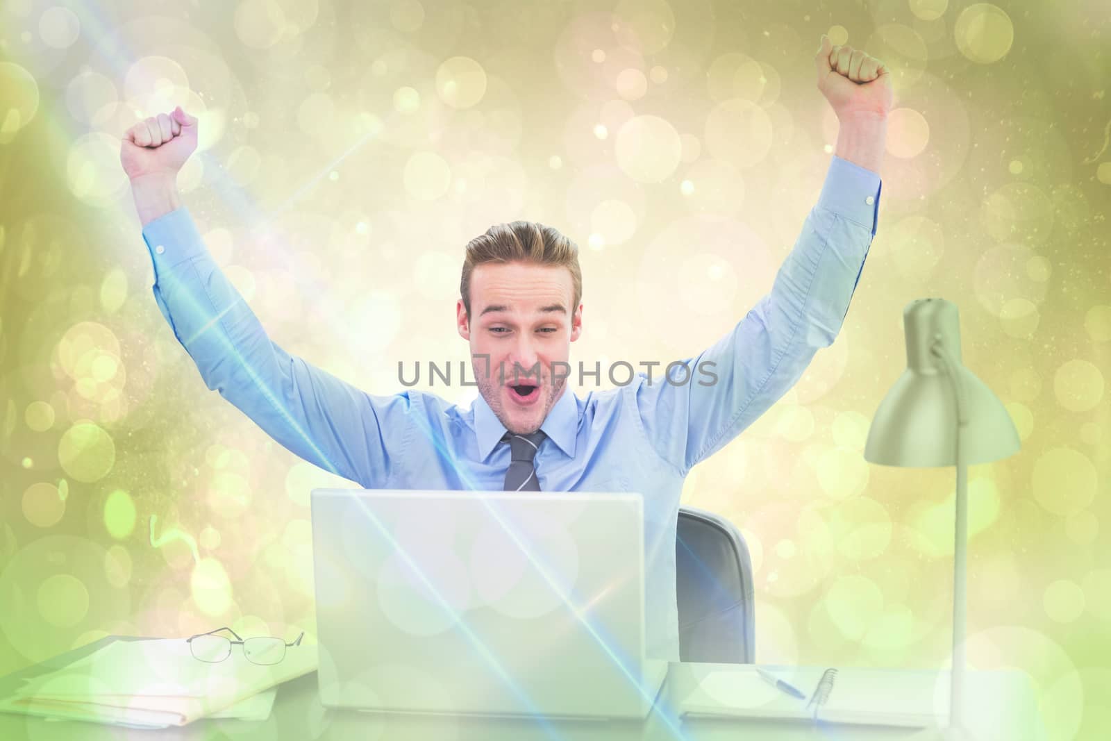 Composite image of cheering businessman at laptop by Wavebreakmedia