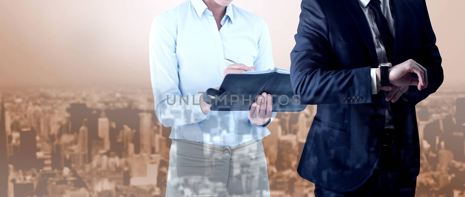 Handsome businessman checking the time against high angle view of city