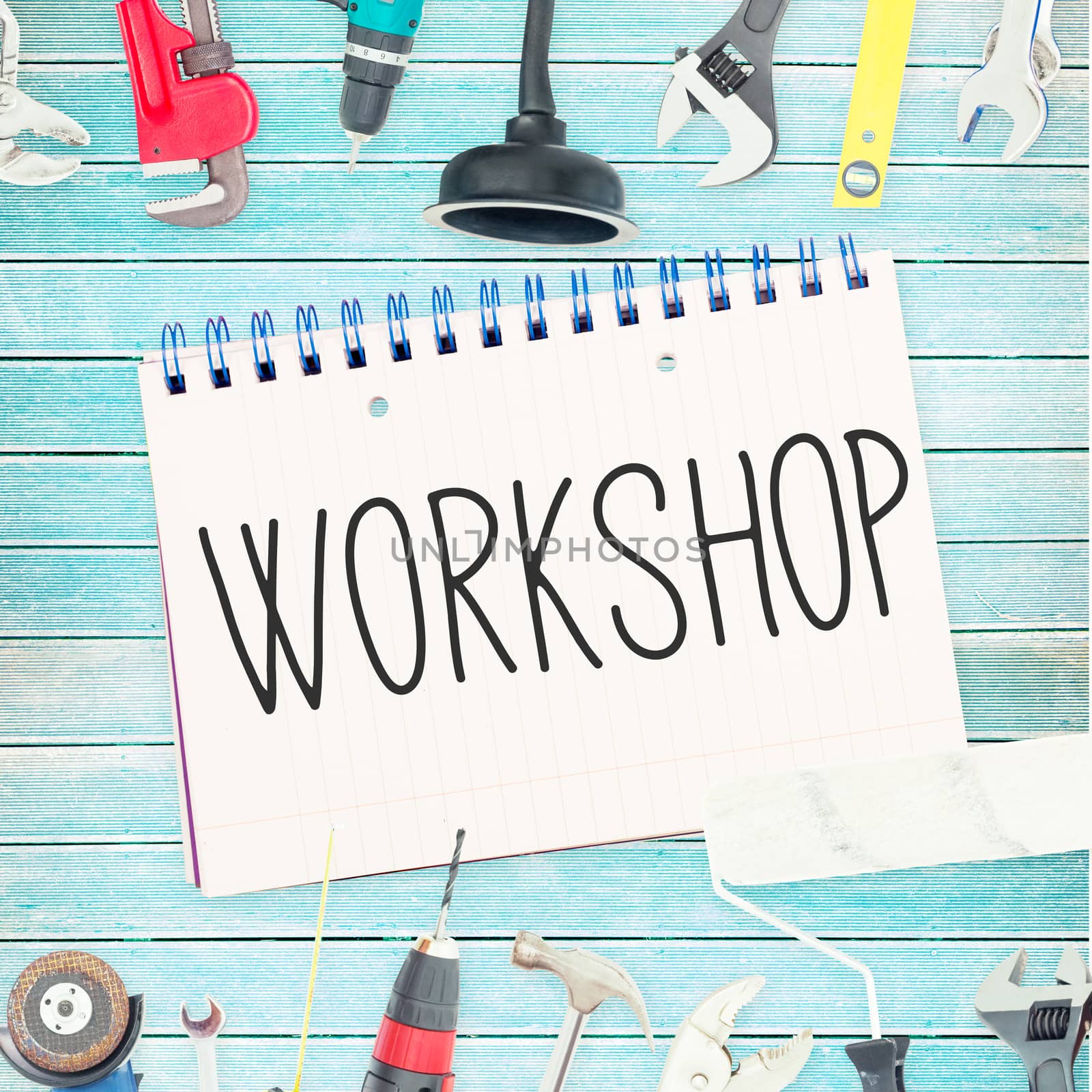 Workshop against tools and notepad on wooden background by Wavebreakmedia