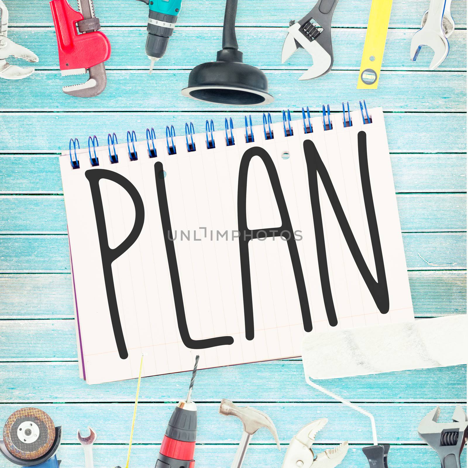 Plan against tools and notepad on wooden background by Wavebreakmedia