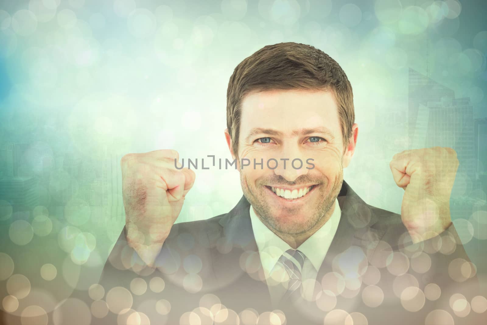 Businessman smiling and cheering against blue abstract light spot design