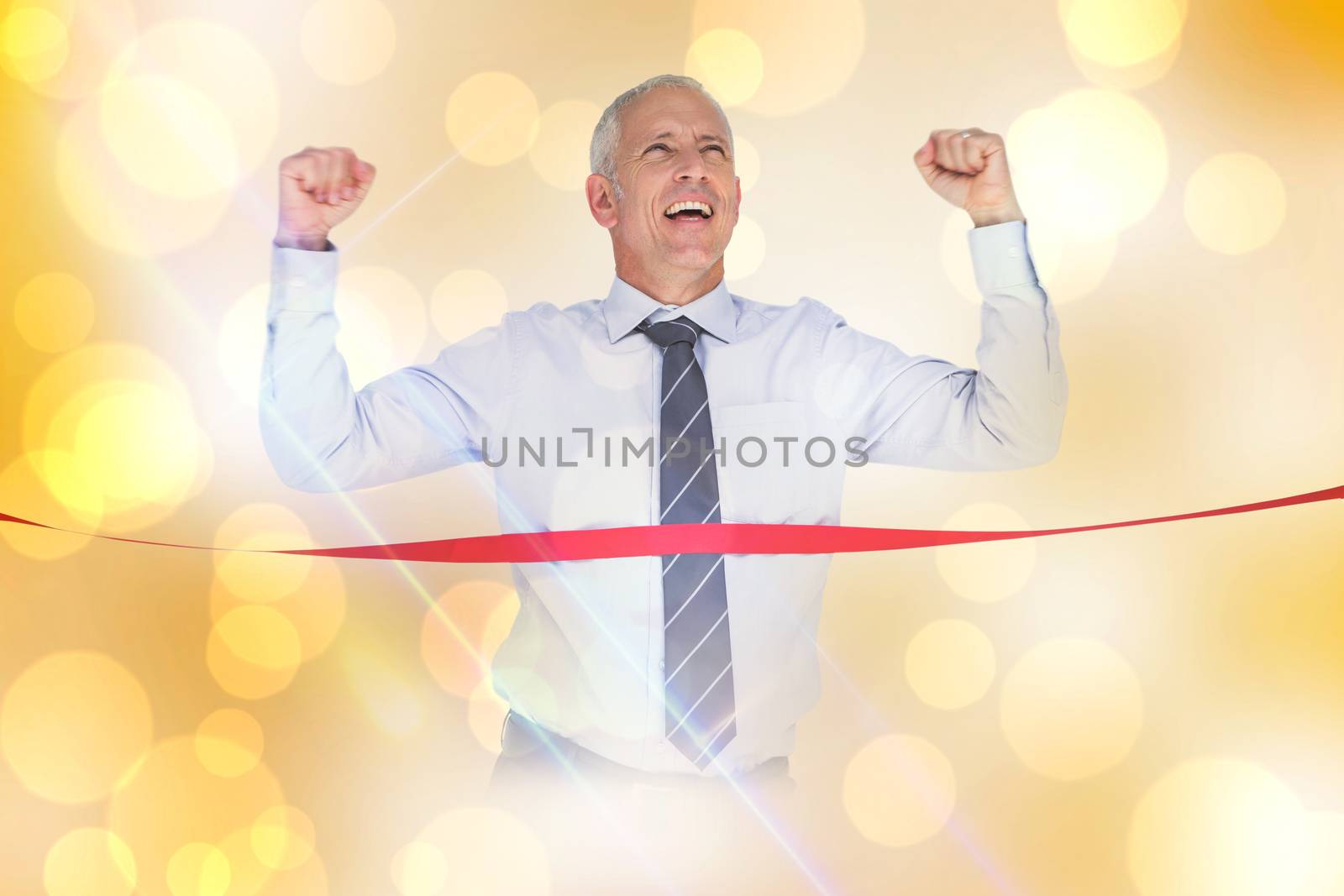 Businessman winning race against yellow abstract light spot design