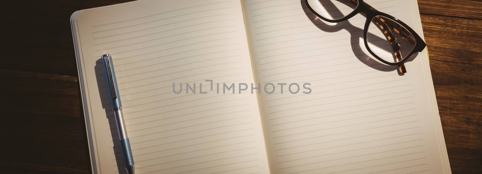 Empty notepad with reading glasses by Wavebreakmedia